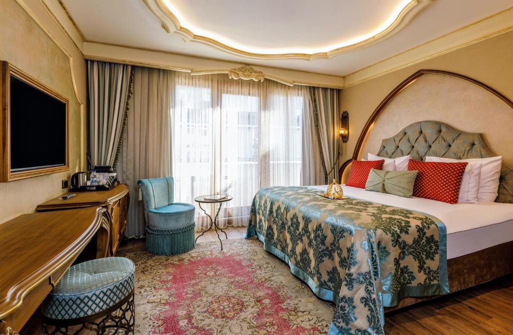 a hotel room with a large bed and a desk at Romance Istanbul Hotel Boutique Class in Istanbul