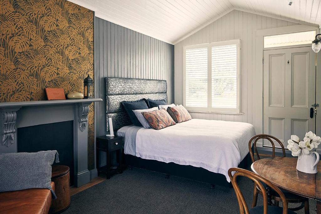 a bedroom with a bed and a table and a window at Dunstan Times in Clyde