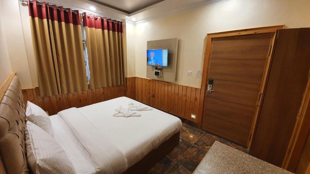 Postel nebo postele na pokoji v ubytování Nomadic Inn
