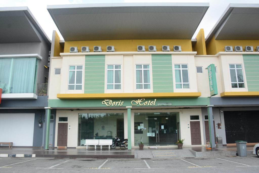 a building with a bench in front of it at Doris Hotel in Melaka
