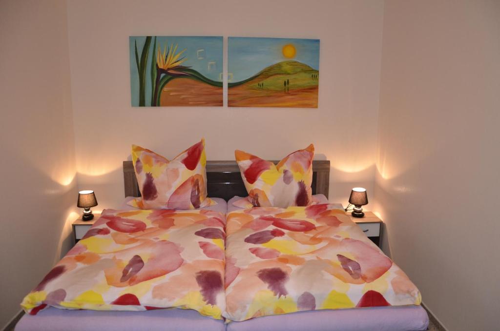 a bedroom with two beds and a painting on the wall at Ferienwohnung in Fuhlenbrock in Bottrop