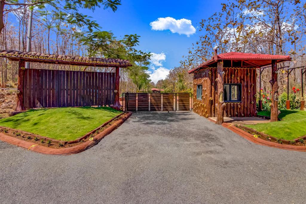 a house with a gate and a yard with grass at Club Mahindra Netrang in Netrang