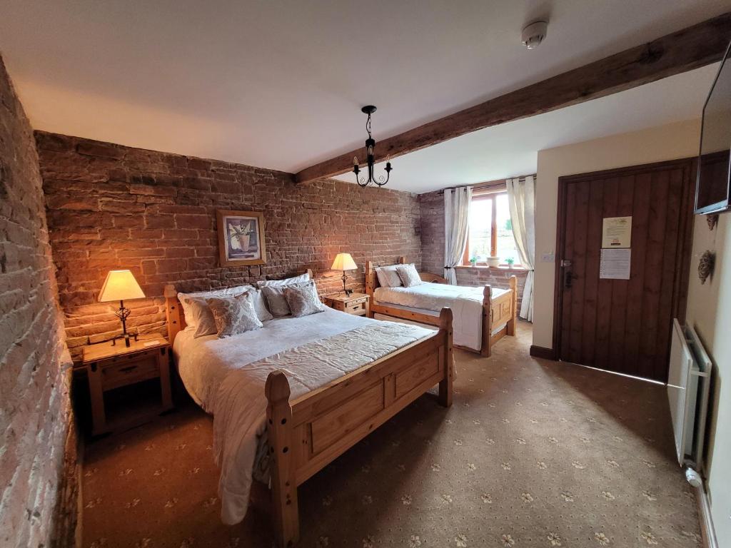 Postel nebo postele na pokoji v ubytování THE GINNEY Country Guest House