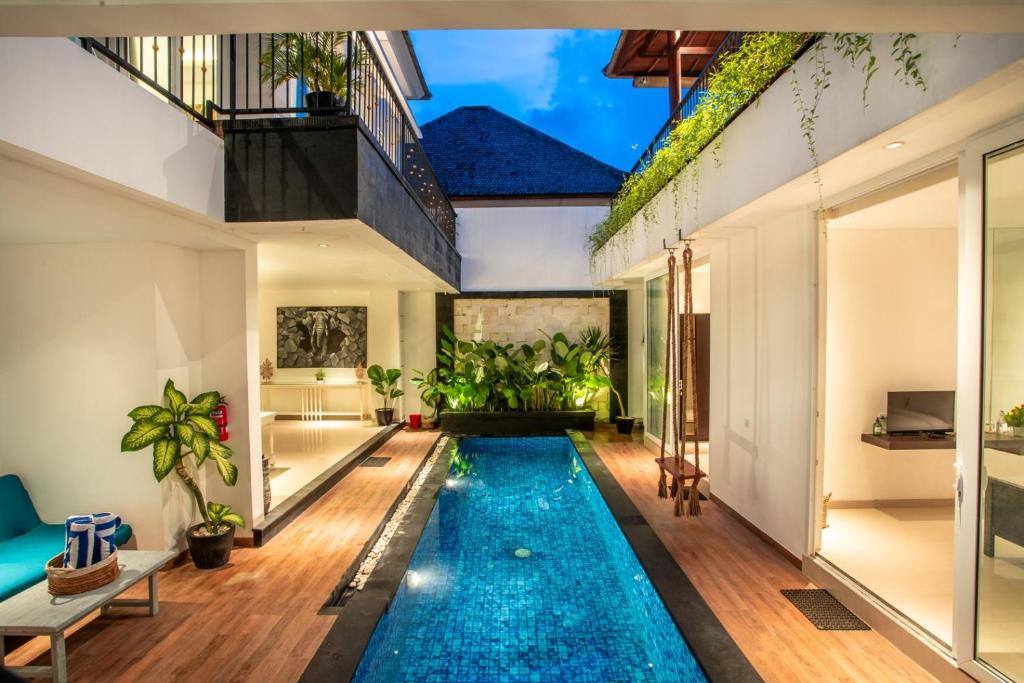 a swimming pool in the middle of a house at La Terra Villas Canggu Kuta Bali in Canggu