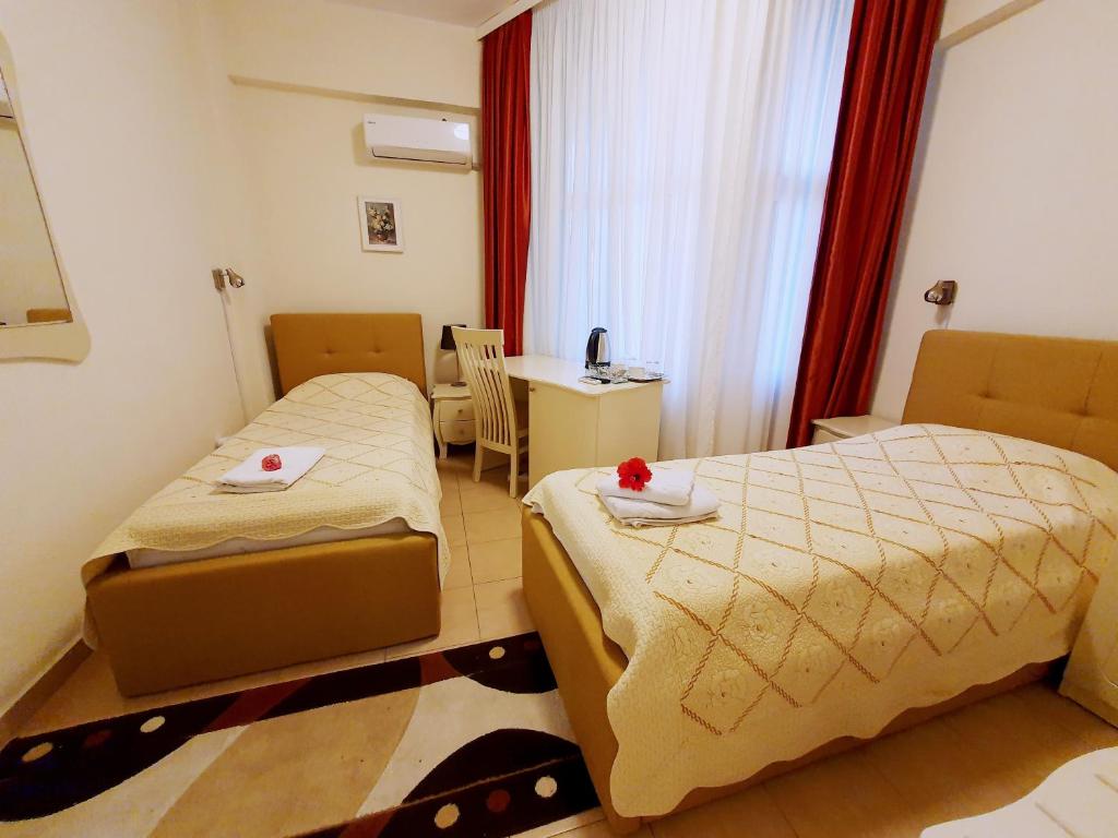 Postel nebo postele na pokoji v ubytování Hotel Florentina