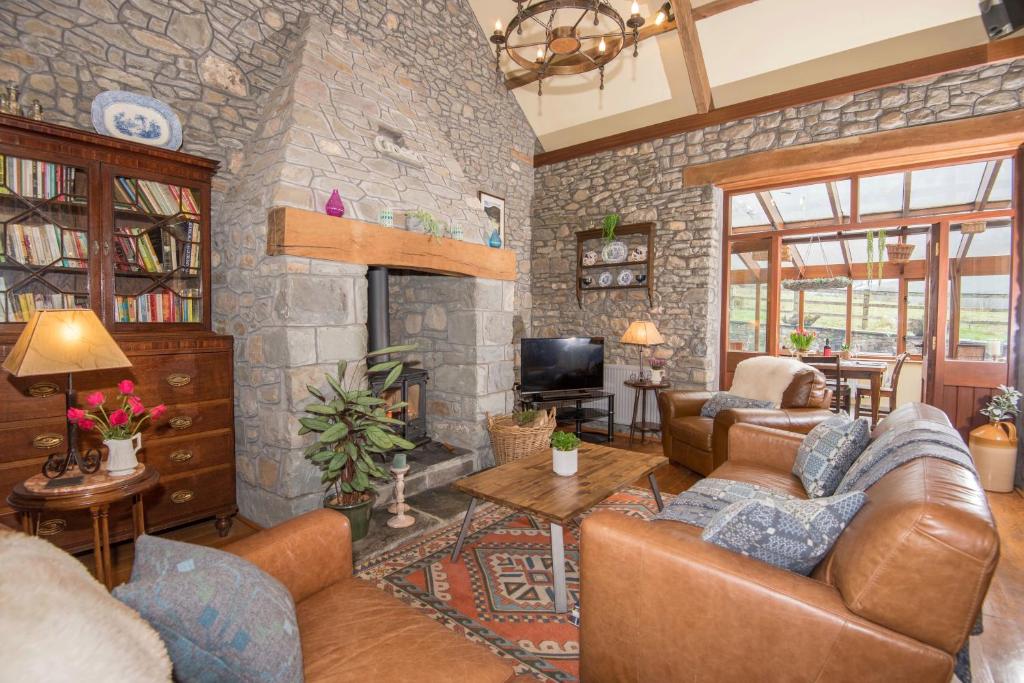 a living room with a stone wall at Cae'r Beili in Llandovery