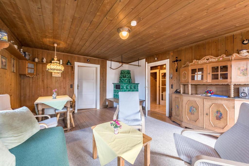 a living room with a couch and chairs and a table at Haus Löweneck in Bayrischzell