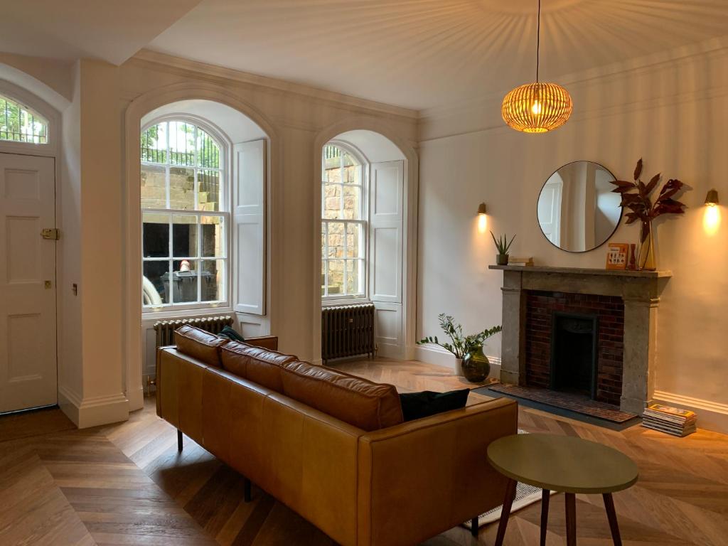 a living room with a couch and a fireplace at Royal Bolthole in Edinburgh