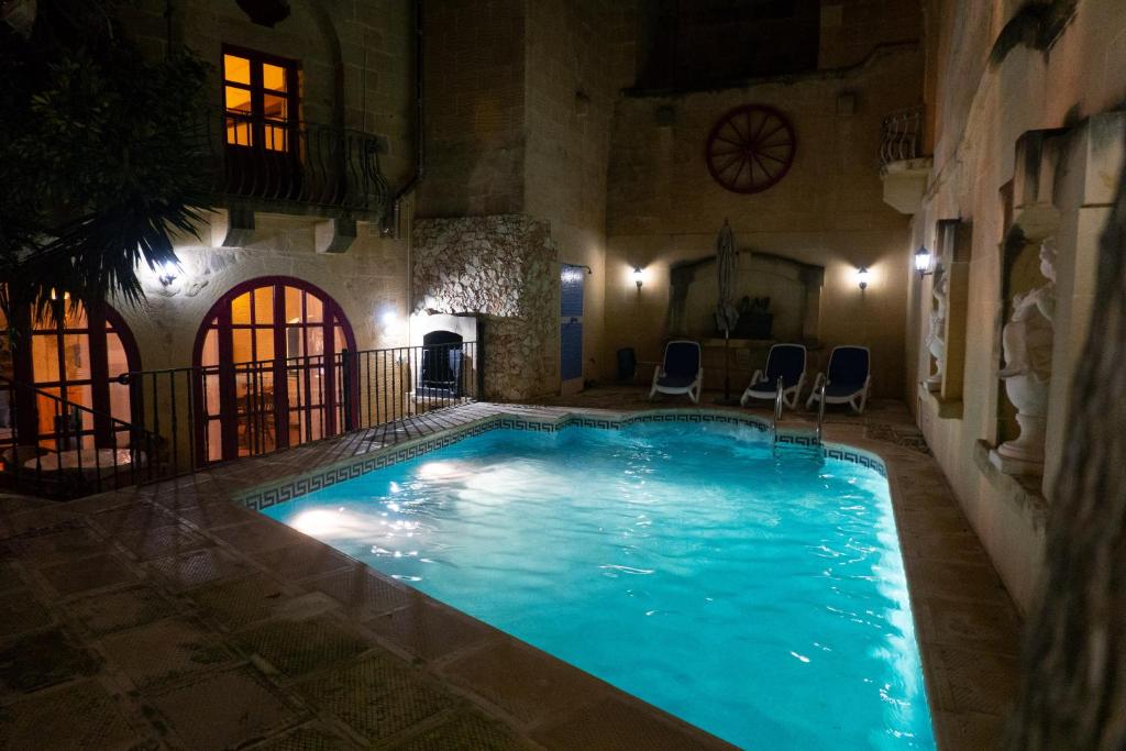 a swimming pool in a house at night at Prickly Pear Holiday Home No.2 in San Lawrenz