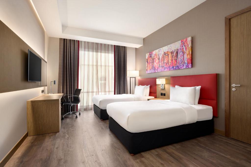 Postel nebo postele na pokoji v ubytování Ramada Encore by Wyndham Muscat Al-Ghubra