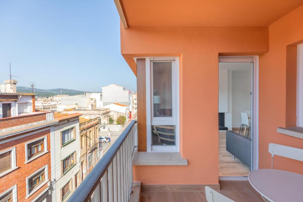 a balcony with a view of a city at Hauzify I Apartament Big Family in Sant Feliu de Guíxols
