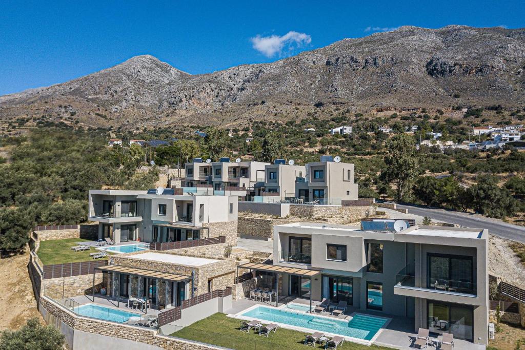 an aerial view of a house with mountains in the background at Porti Villas Iraklis in Asómatoi