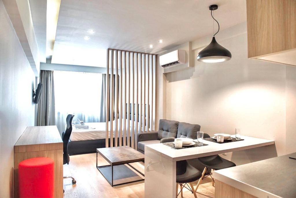 a kitchen and living room with a table and chairs at #Aura Studios & Suites V9-10 in Thessaloniki