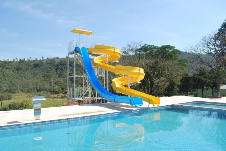 a water slide in a swimming pool at Recanto Julubi Atibaia in Atibaia
