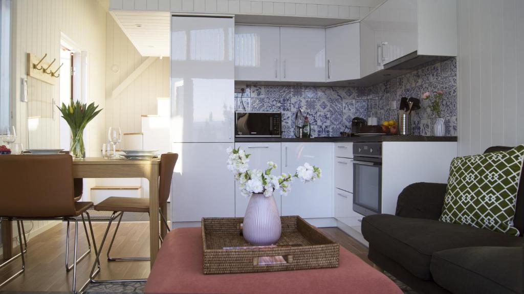 a living room with a vase of flowers on a table at Bålsta Studio Houses in Bålsta