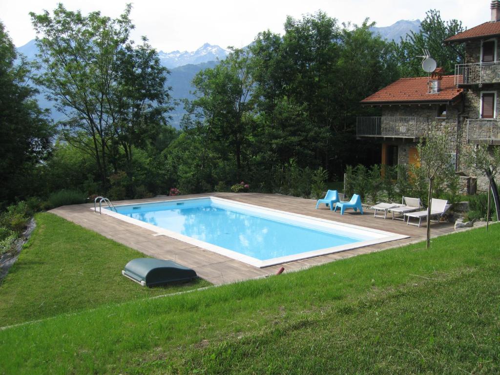 a swimming pool in a yard next to a house at Casale Antico Borgo in Colico