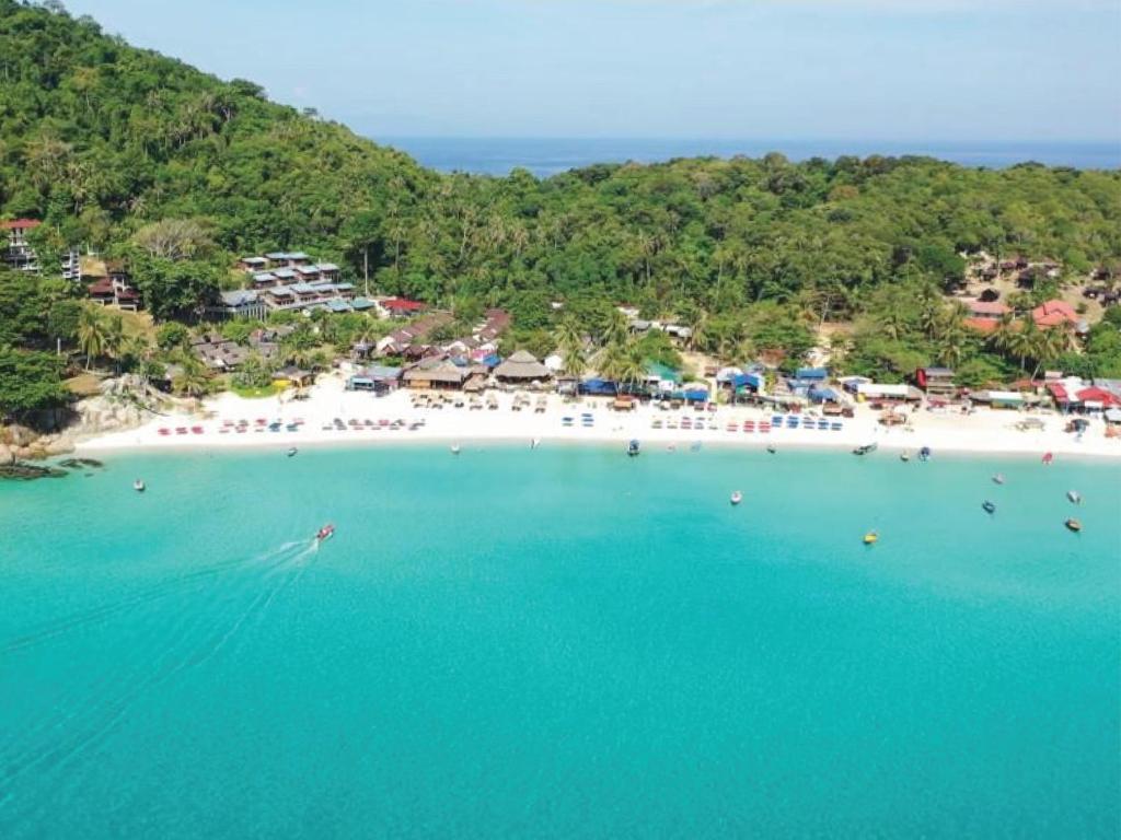 an aerial view of a beach with people in the water at Harrera Perhentian, Long Beach in Perhentian Islands