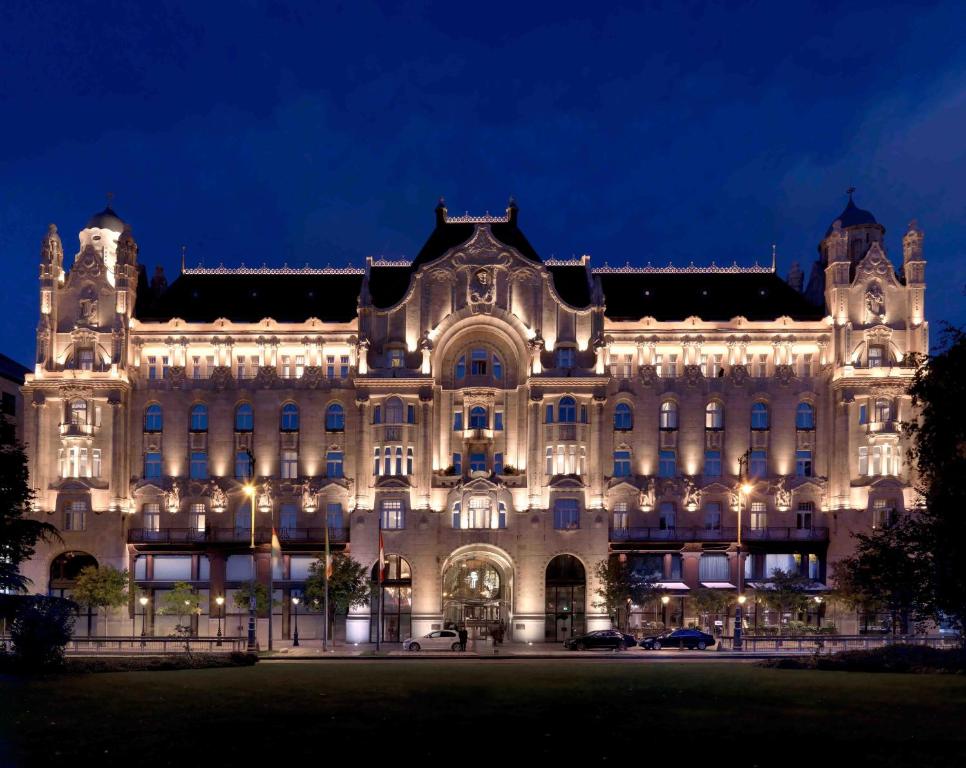 duży budynek oświetlony w nocy w obiekcie Four Seasons Hotel Gresham Palace Budapest w Budapeszcie