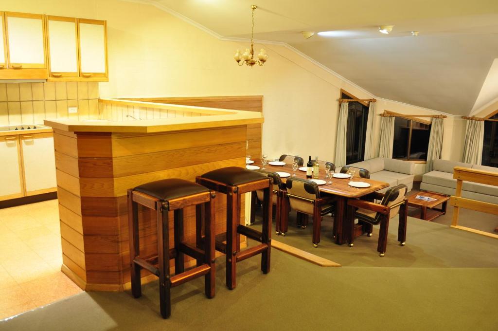 a kitchen and dining room with a table and chairs at Salzburg Apartments in Perisher Valley