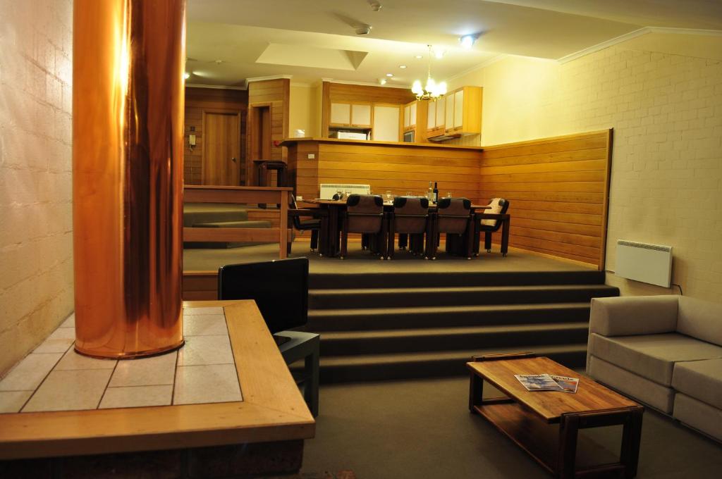 a living room with a table and a dining room at Salzburg Apartments in Perisher Valley