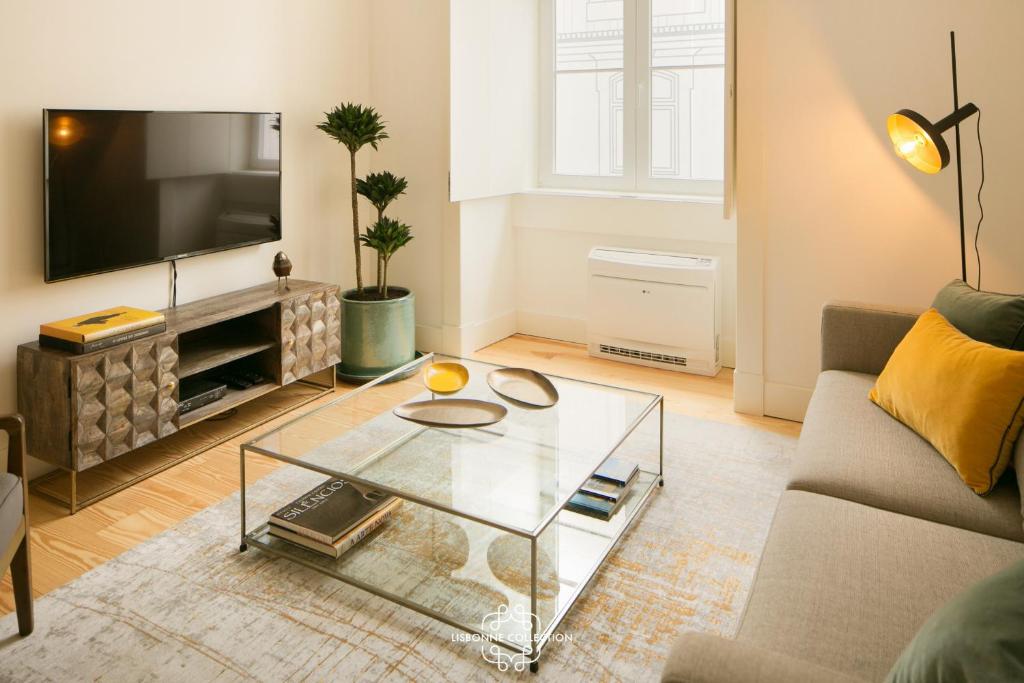 a living room with a couch and a glass coffee table at Downtown Sleek Apartment 65 by Lisbonne Collection in Lisbon