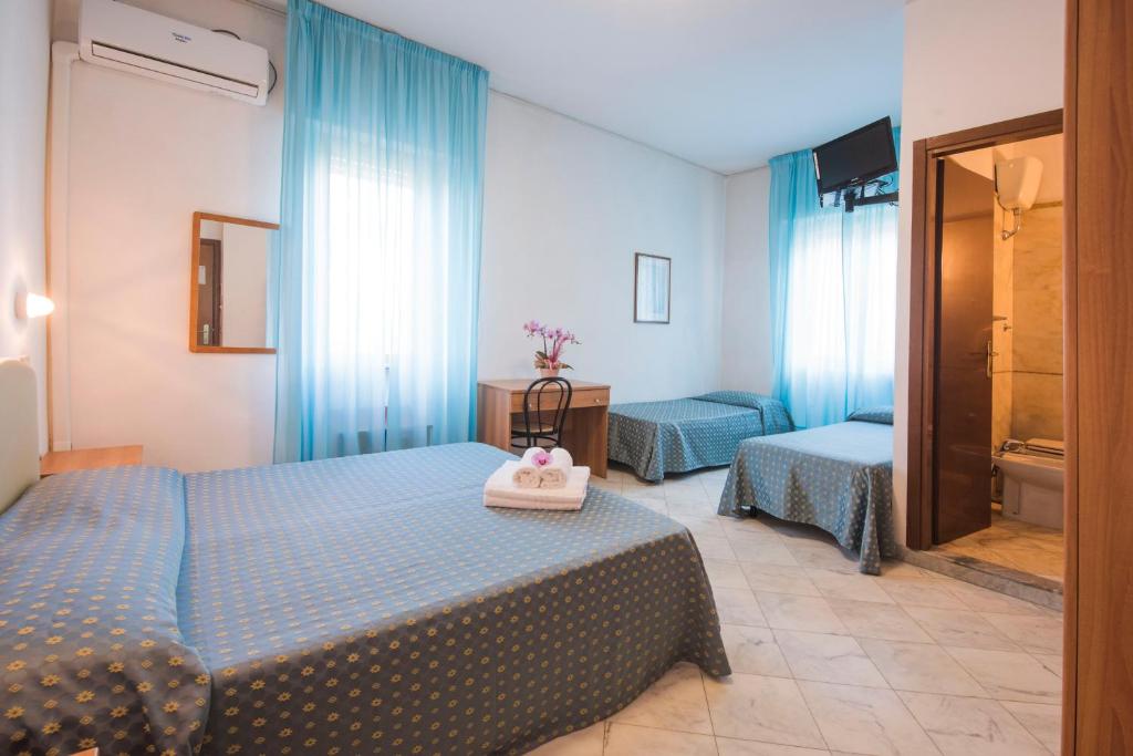 Postel nebo postele na pokoji v ubytování Hotel Mariotti