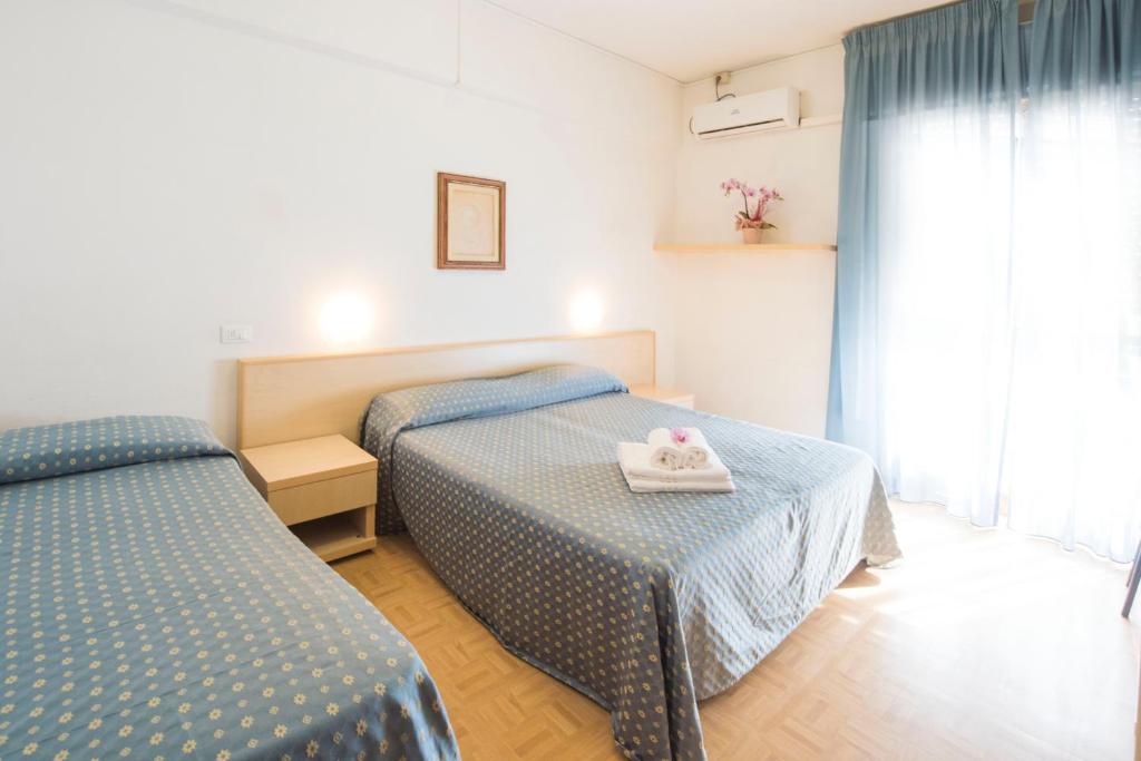 Postel nebo postele na pokoji v ubytování Hotel Mariotti