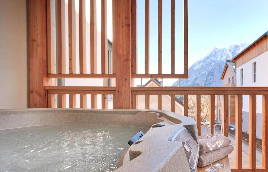 a hot tub on the balcony of a house at die Tauplitz Lodges - Alm Lodge A5 by AA Holiday Homes in Tauplitz