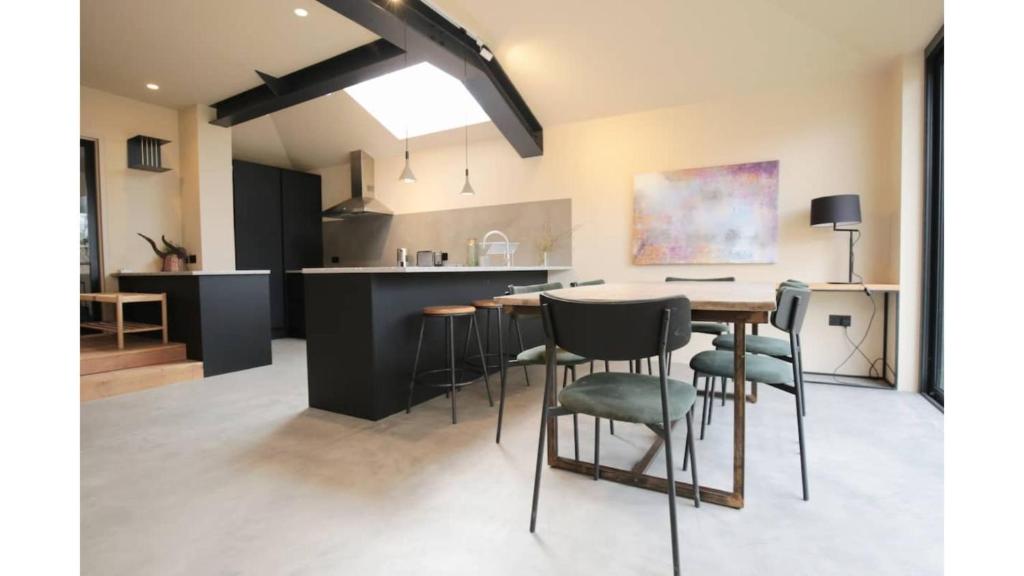 uma cozinha e sala de jantar com mesa e cadeiras em Pass the Keys Stunning, Brand New 3BR Home - Central Oxford em Oxford