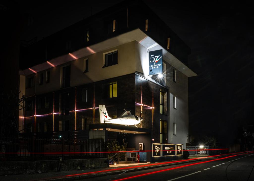 a building with a sign on it at night at 57 Reshotel Orio in Orio al Serio