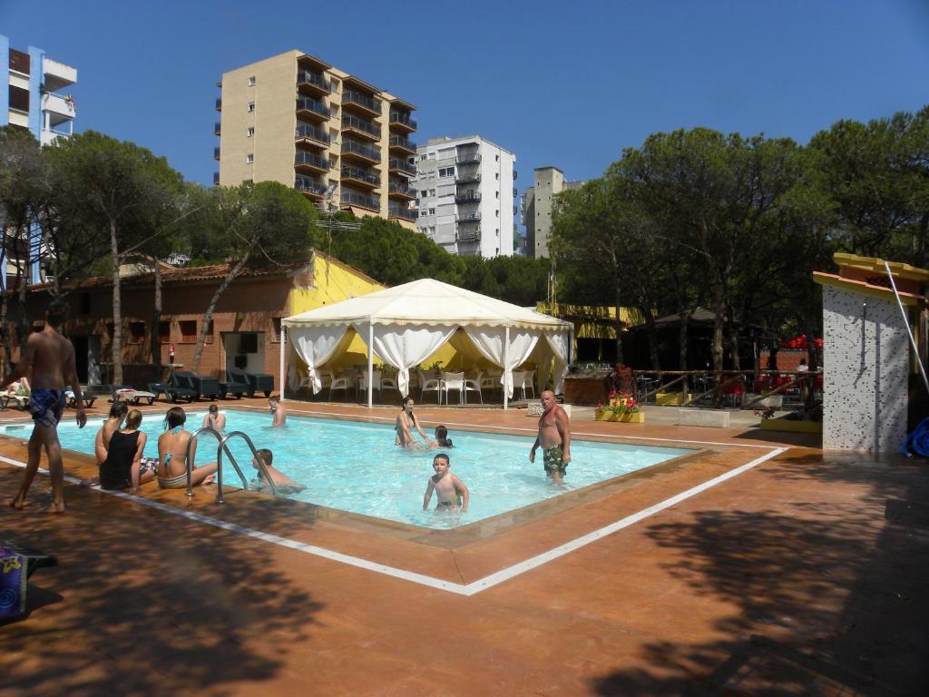 a group of people playing in a swimming pool at Camping Sabanell in Blanes