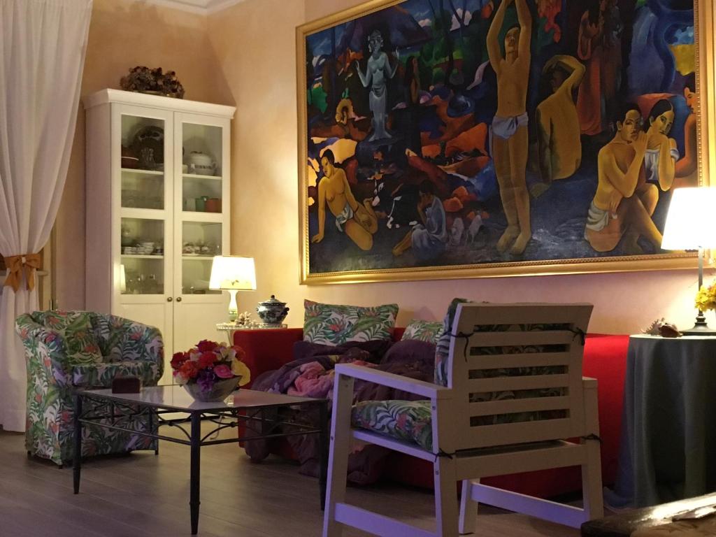 a living room with a painting on the wall at Lovely Versilia Tuscany in Torre del Lago Puccini