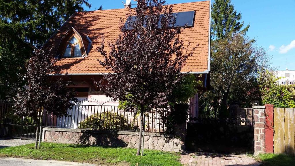 une maison avec un arbre en face dans l'établissement Holiday home in Fonyod/Balaton 18705, à Fonyód