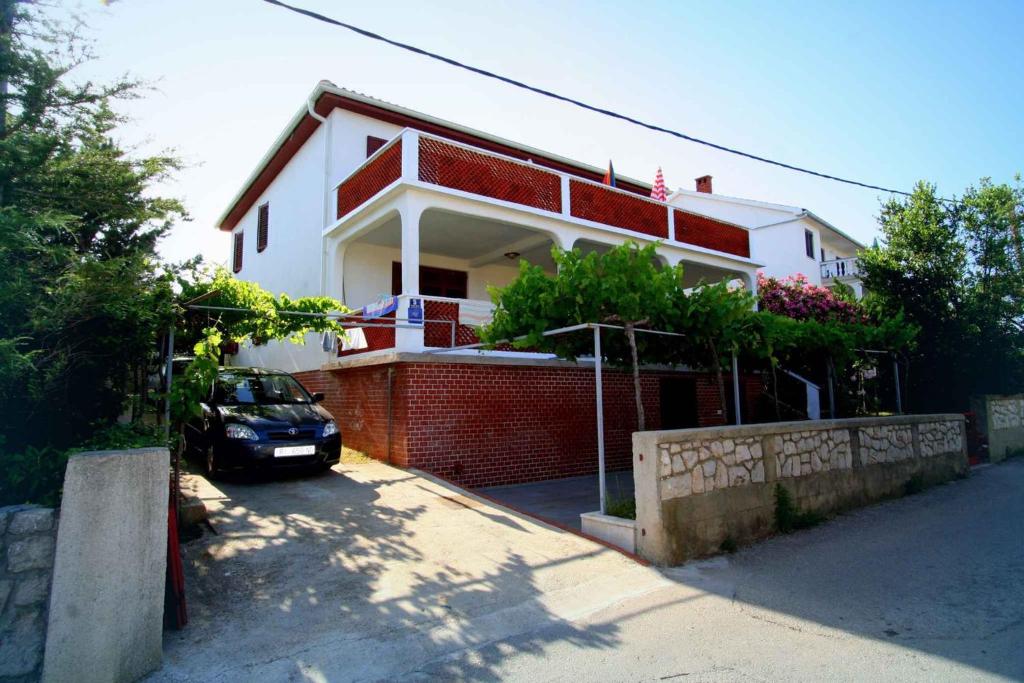 a house with a car parked in front of it at Apartment in Silo/Insel Krk 14539 in Šilo