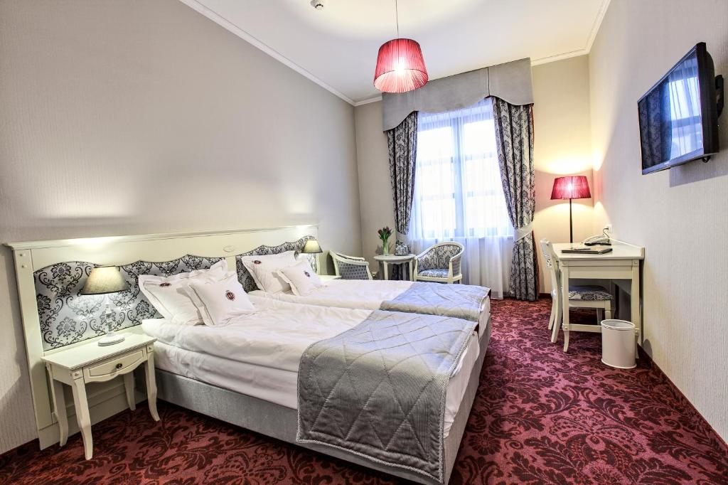 Posteľ alebo postele v izbe v ubytovaní Hotel Jarosław