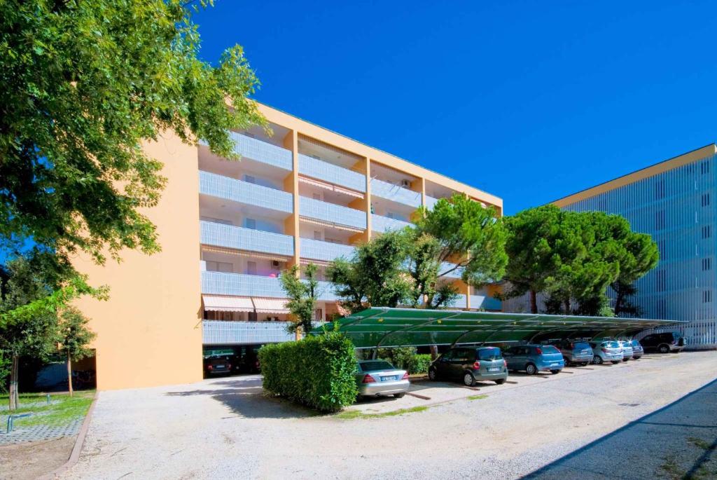 a large building with a boat parked in a parking lot at Studio in Bibione 24407 in Bibione