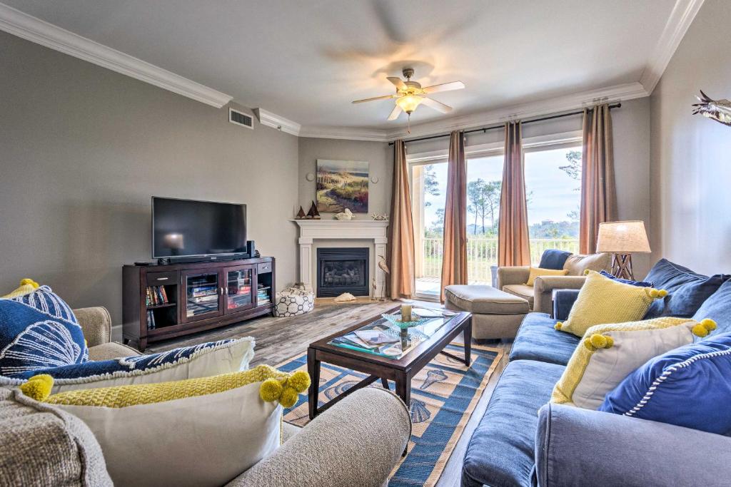 a living room with blue couches and a tv at 30A Retreat with Patio and Resort Amenities! in Santa Rosa Beach