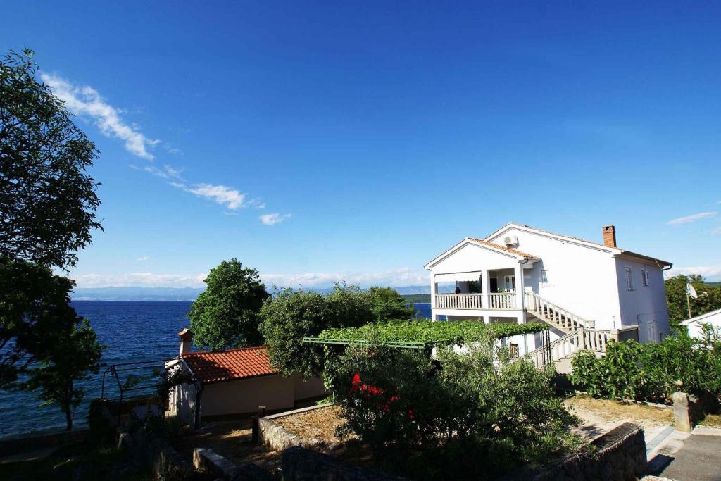a white house with a view of the water at Apartment in Malinska/Insel Krk 12860 in Vantačići