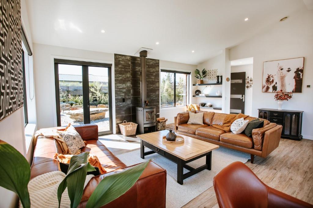 a living room with a couch and a table at Minaret Ridge - Family Friendly - Sleeps 8 - Mountain Views - Close to Lake in Wanaka