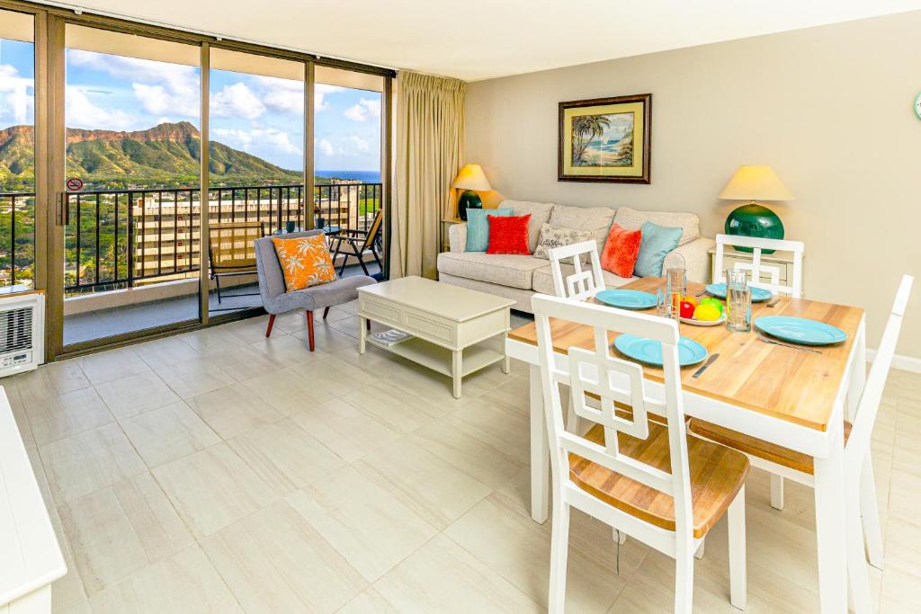 a living room with a table and a couch at Diamond Head & Ocean View Gem Near Waikiki Beach, Parking's On Us in Honolulu