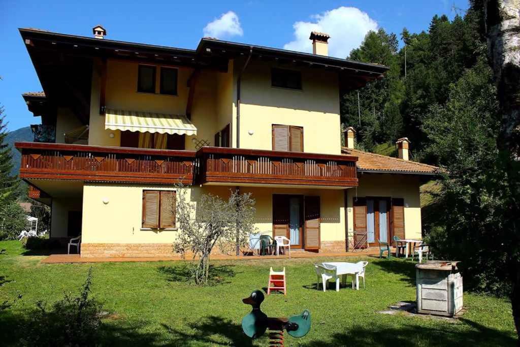 a large house with a yard in front of it at Apartments in Pieve di Ledro/Ledrosee 22632 in Ledro