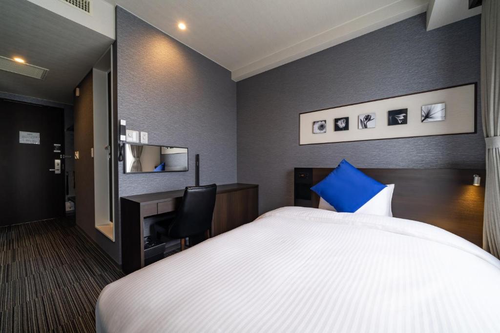 Postel nebo postele na pokoji v ubytování Goi Grand Hotel