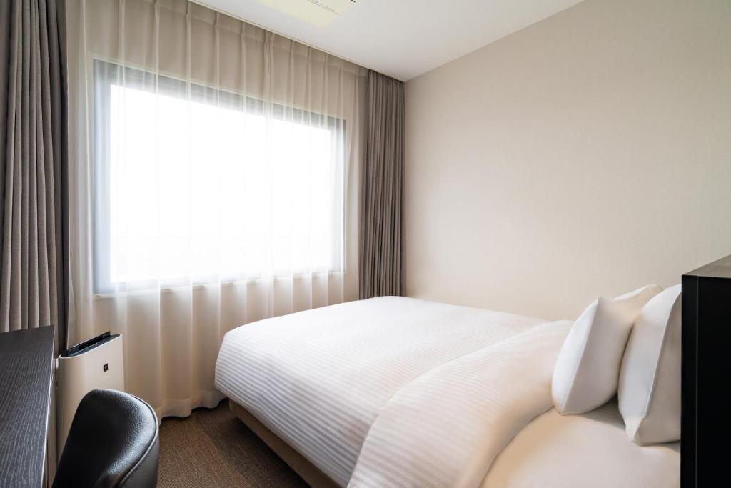 Postel nebo postele na pokoji v ubytování Goi Grand Hotel