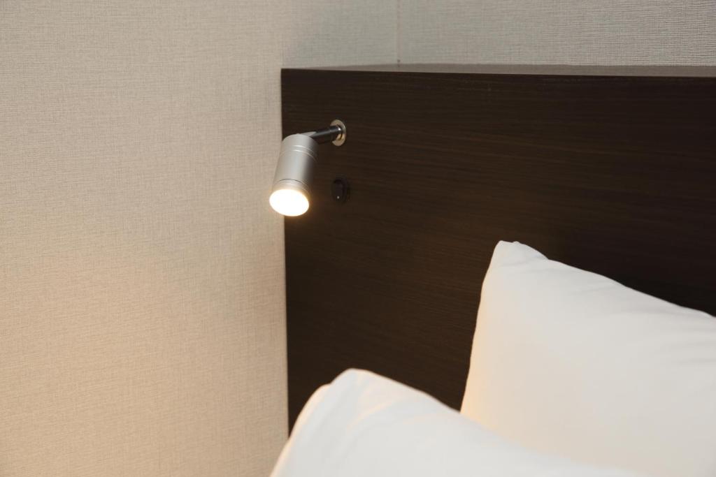 Postel nebo postele na pokoji v ubytování Goi Grand Hotel