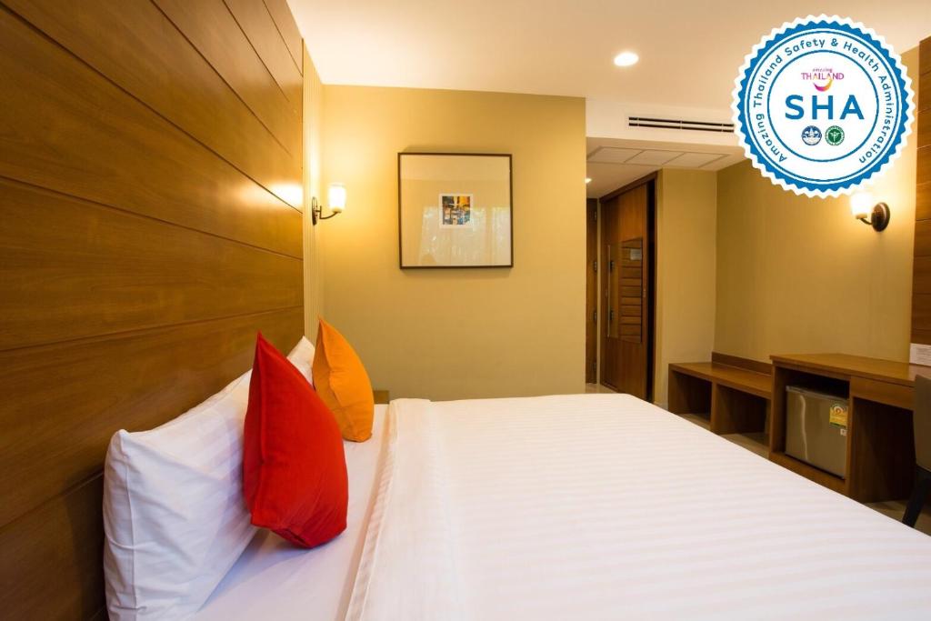 A double room centered on a large bed with a wood-panel wall and built-in storage.