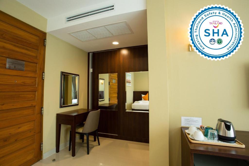 A compact in-room work and refreshment area with a vanity desk and beverage tray.