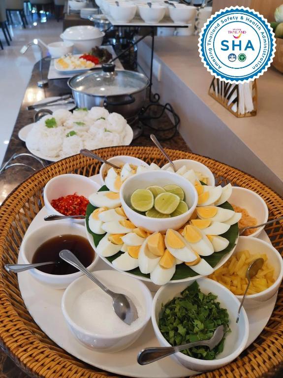 A buffet-style breakfast spread with rice, eggs, vegetables and sauces.