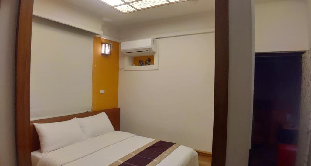 Postel nebo postele na pokoji v ubytování Purple Shell Homestay