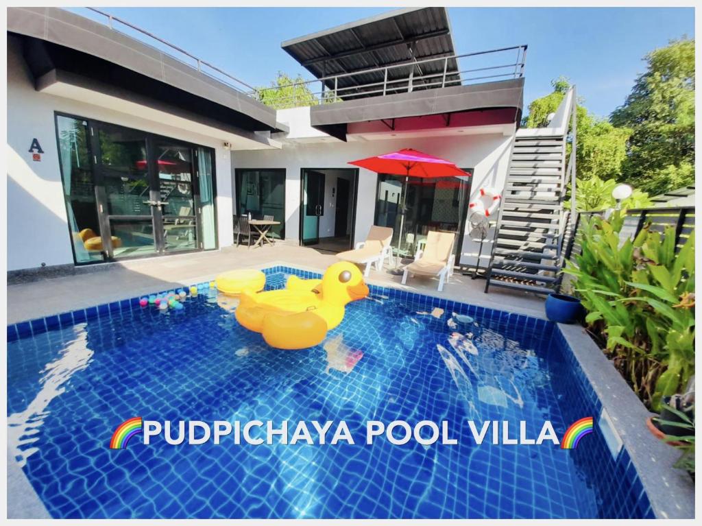 uma piscina com um pato de borracha no meio de uma casa em Pudpichaya Pool Villa em Ban Sahakham