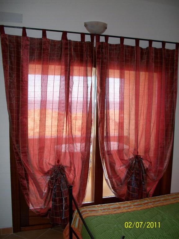 Postel nebo postele na pokoji v ubytování Miramare Isola Rossa